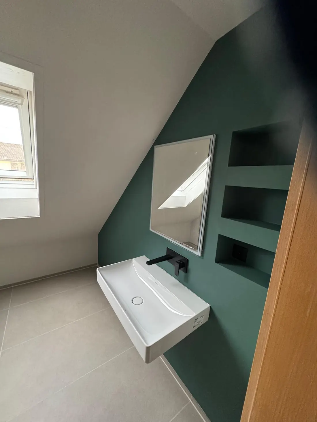 Fertig verputztes und gestrichenes Badezimmer mit dunkelgrüner Wand